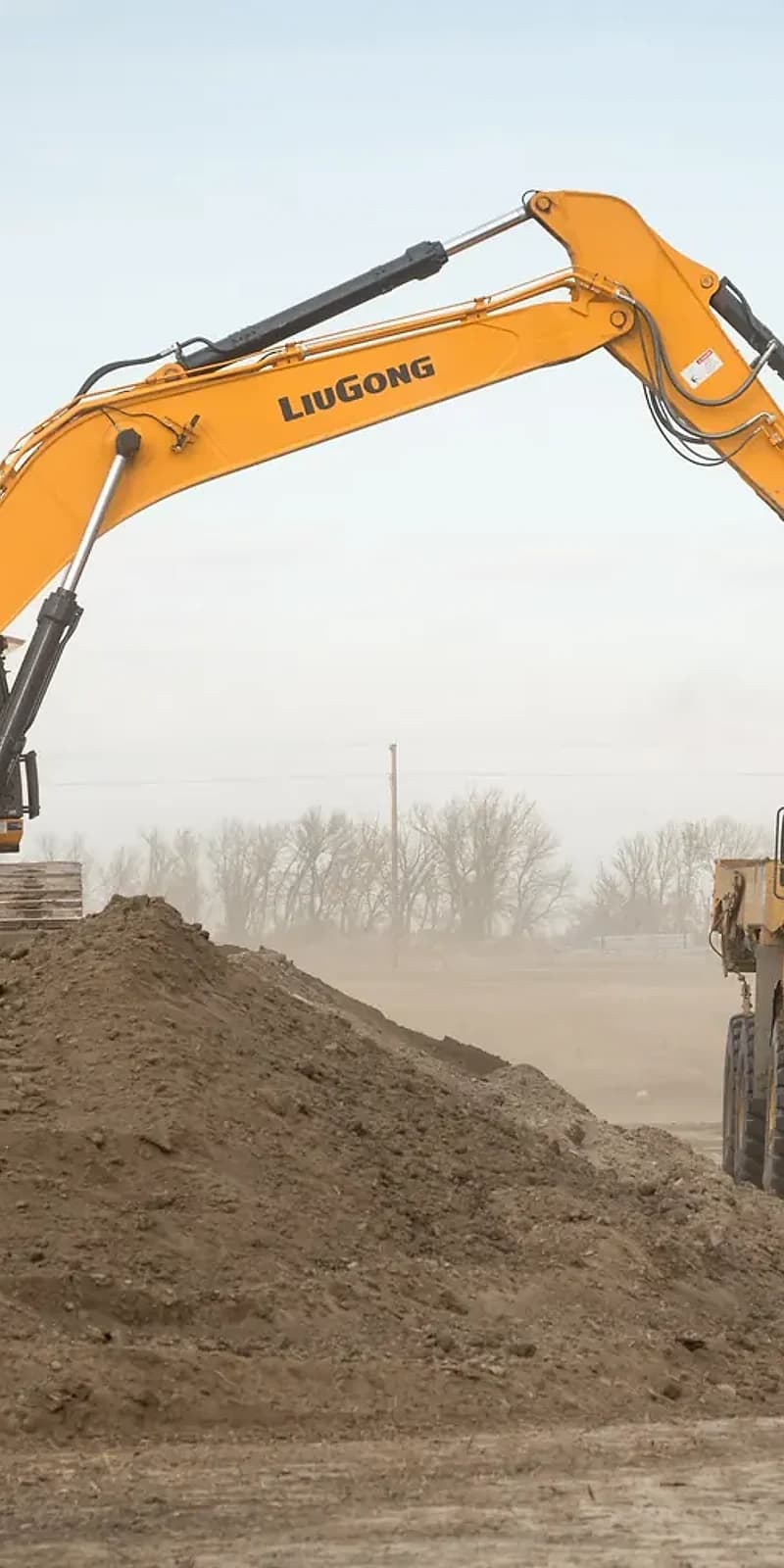 Subterrain excavator boom working above an earthmoving site in Southern Alberta