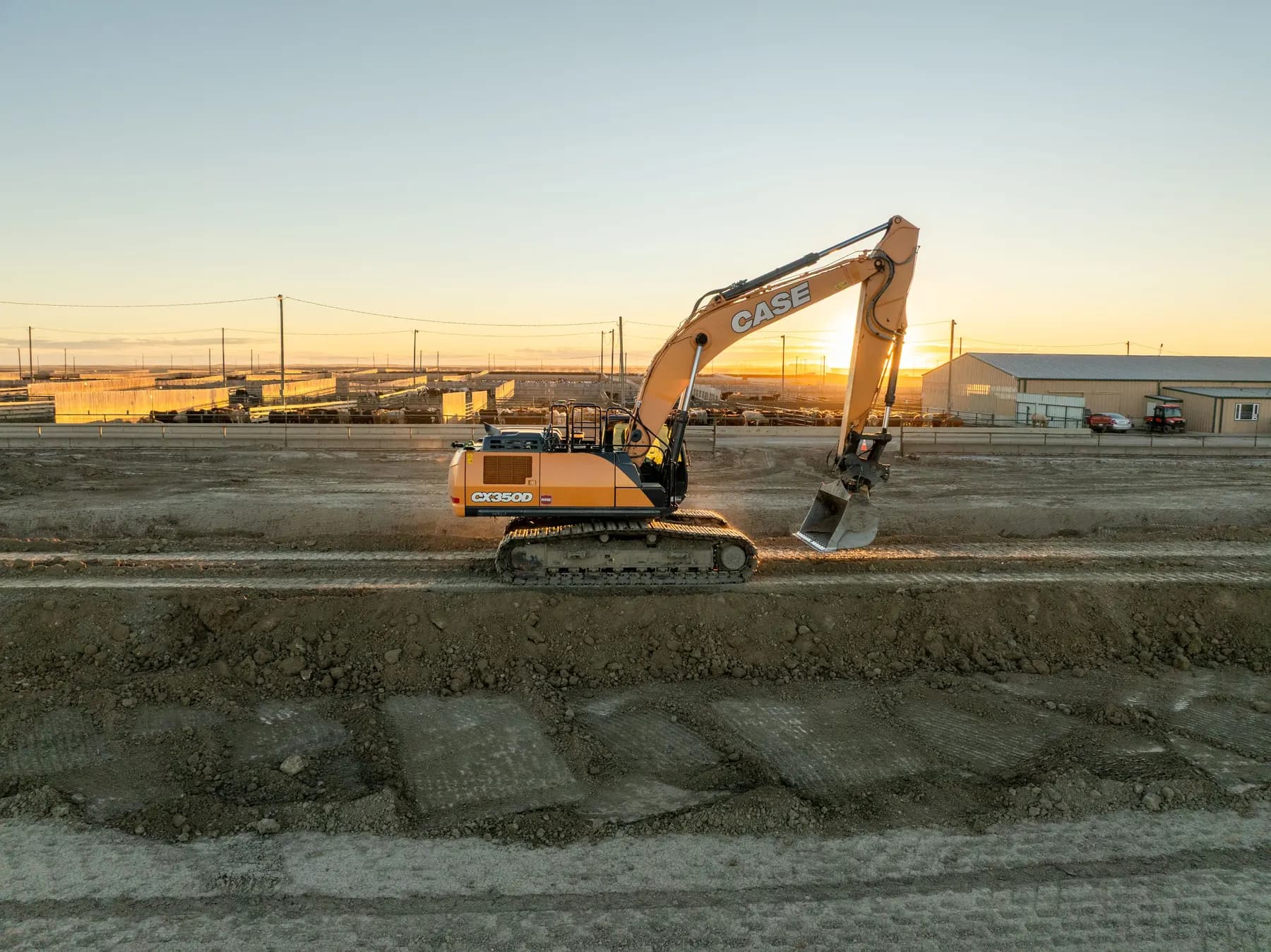 Subterrain excavator working at a Southern Alberta feedlot at sunset